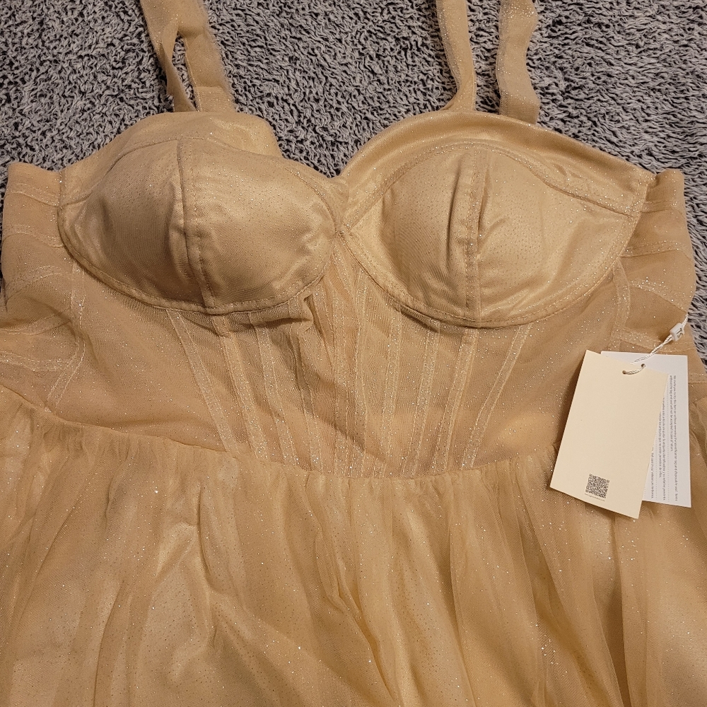 A shimmery gold tulle dress that will work well for a formal occasion.